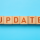 The word update in wooden block on blue background